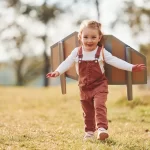 cute-little-girl-with-handmaded-wings-running-outdoors-field-having-fun copy 